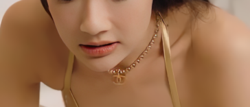 Aokbab Chutimon in a stylish bikini top, holding her Chanel bag